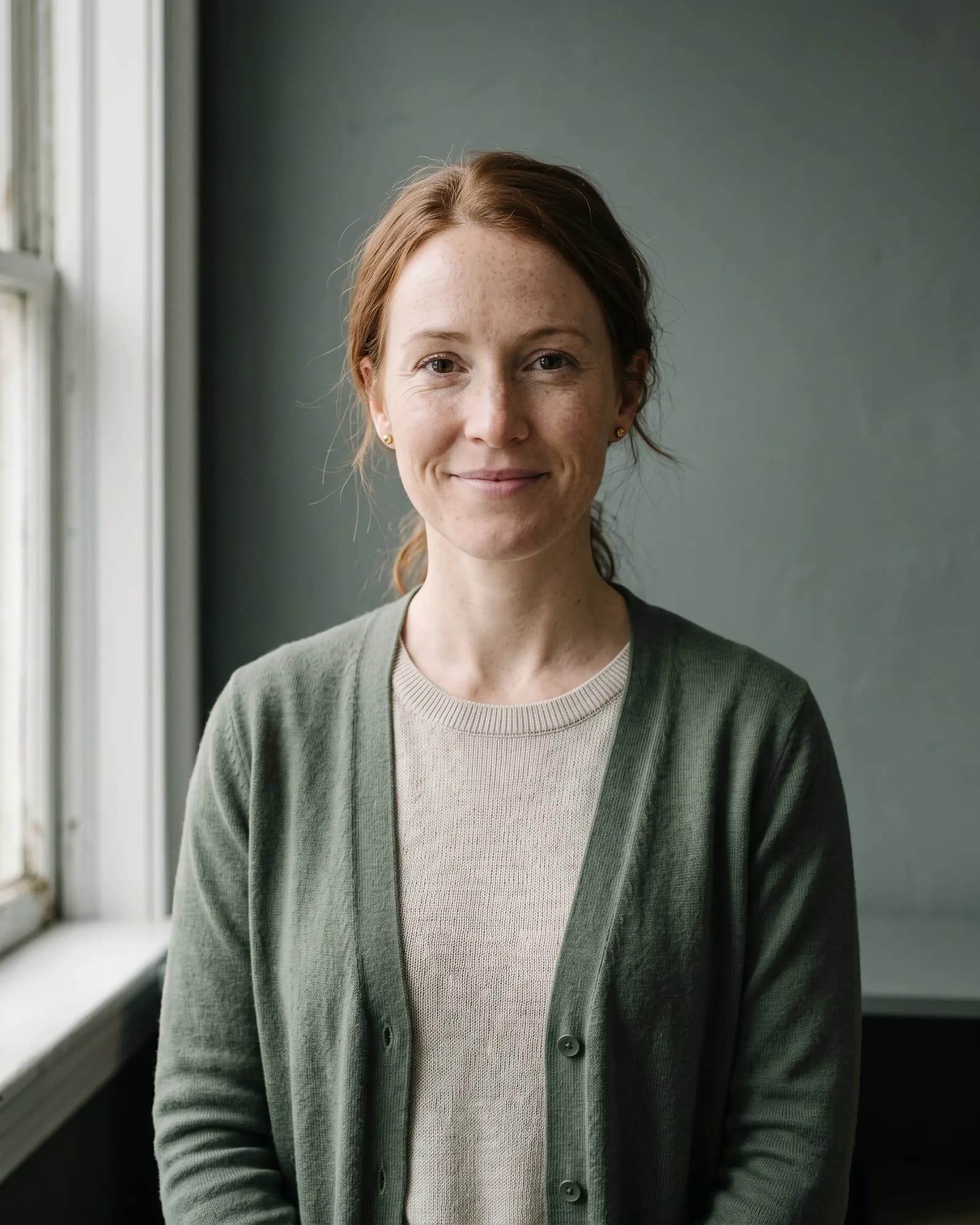Portrait of Hannah Greer, a woman in her thirties with auburn hair tied back.