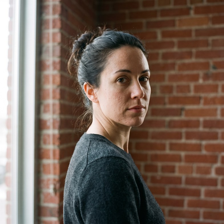A Renner Group agent photographed against exposed brick.