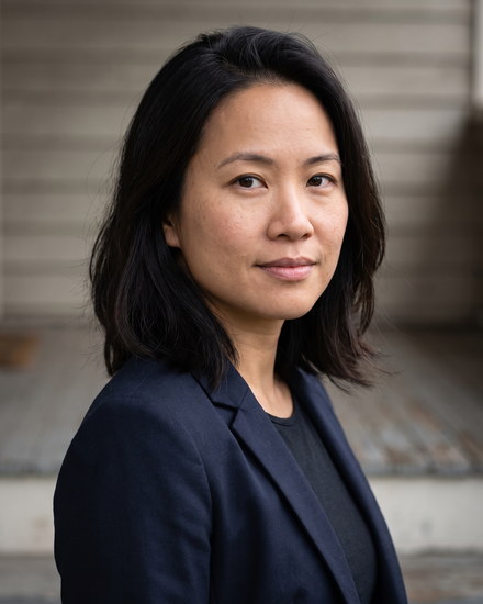 Nora Pham standing on a bungalow porch in Woodland Heights.