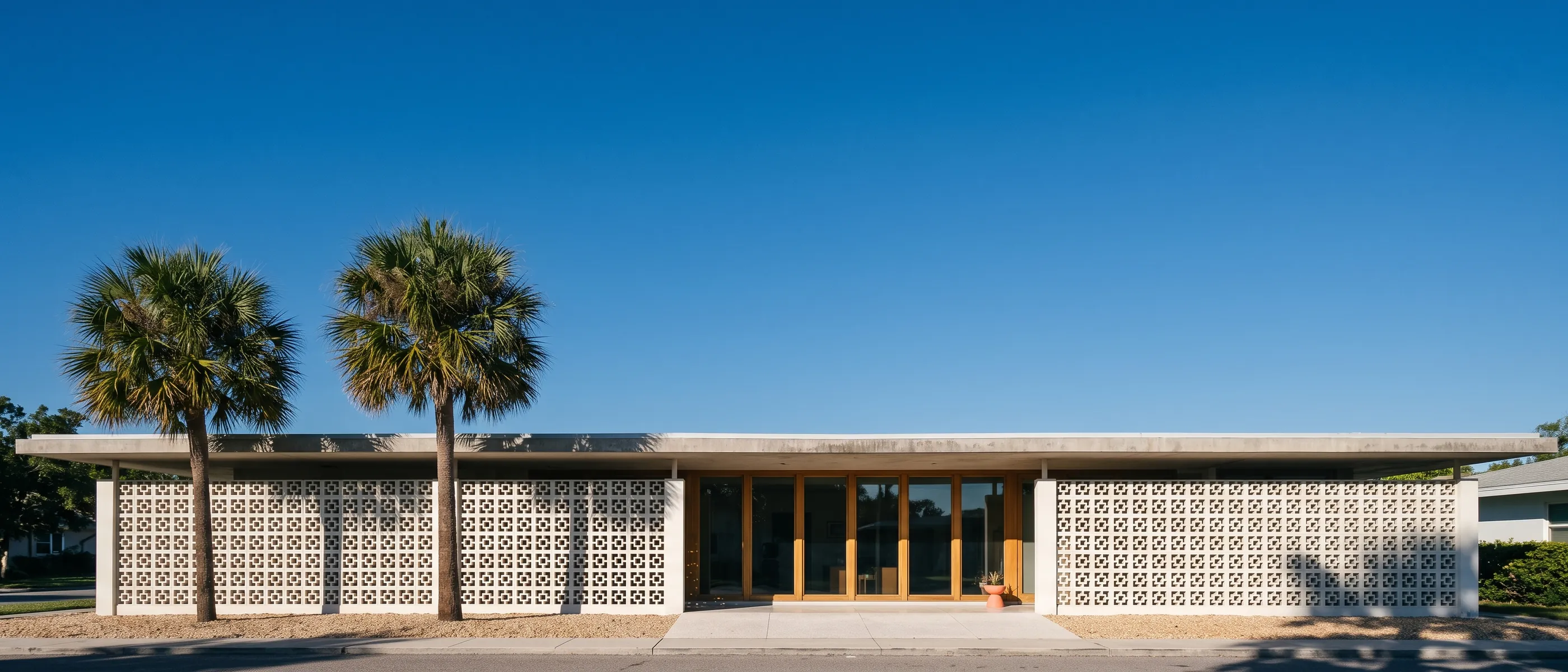 The firm's mid-century office building in Sarasota under a clear morning sky