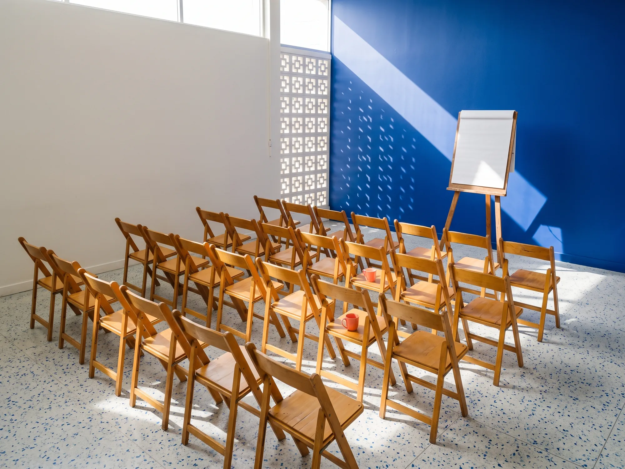 The workshop room set with rows of folding chairs before a class