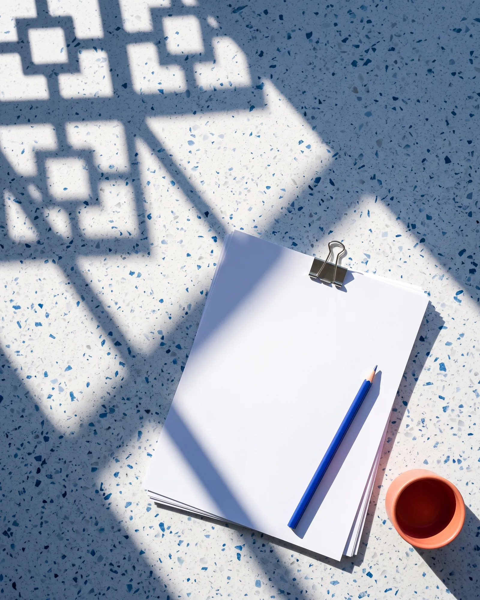 The take-home worksheet with a blue pencil on a terrazzo desk