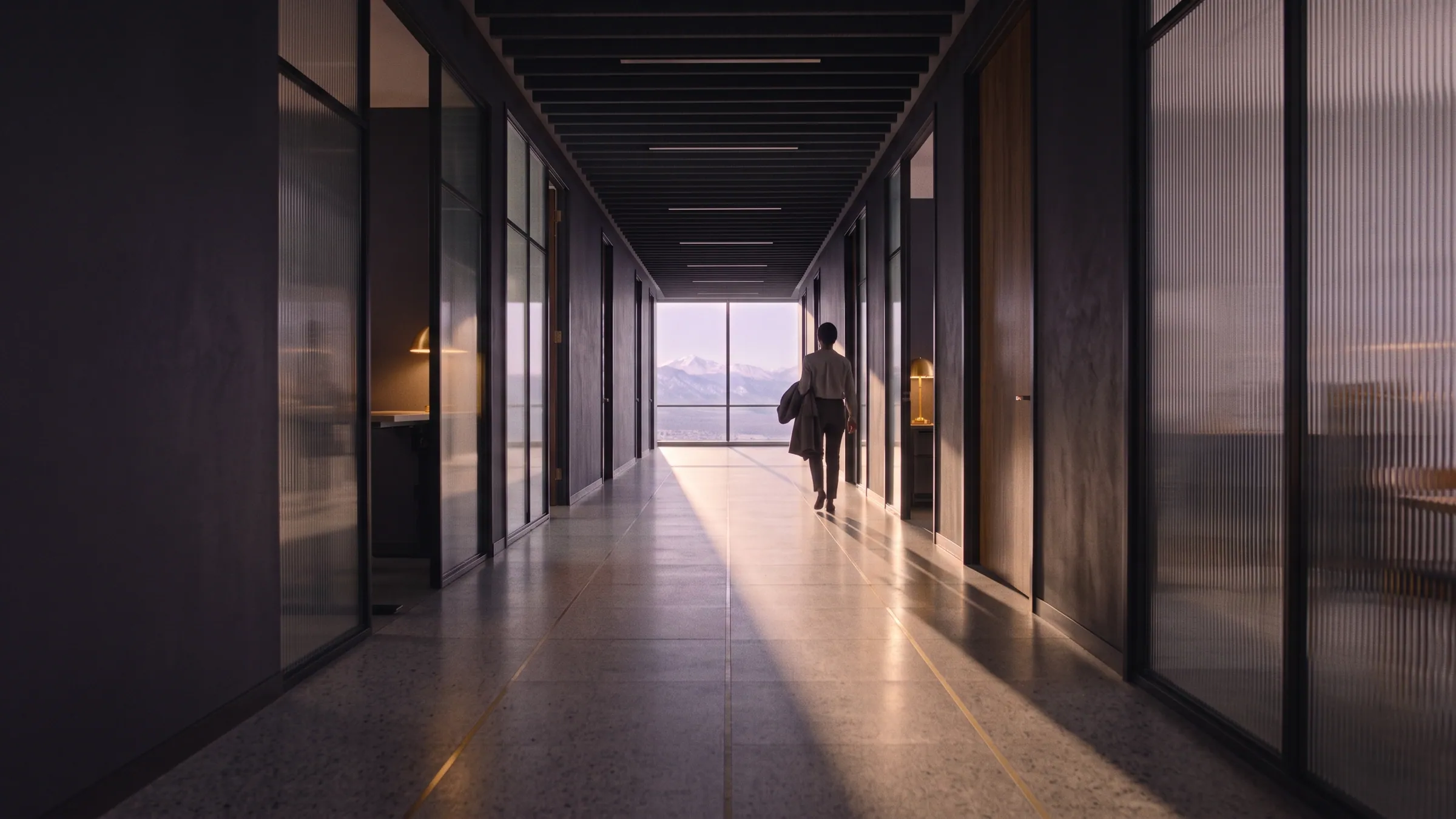Late afternoon sun lying along the corridor floor as someone heads home.