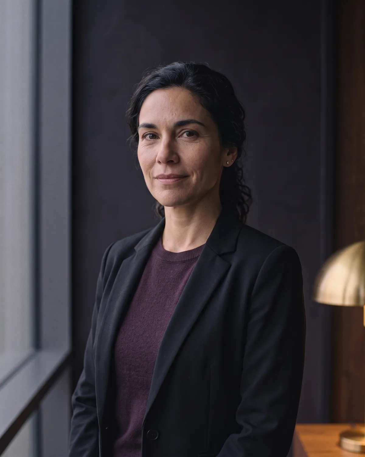Portrait of Naomi Escalante, a fictional senior associate.